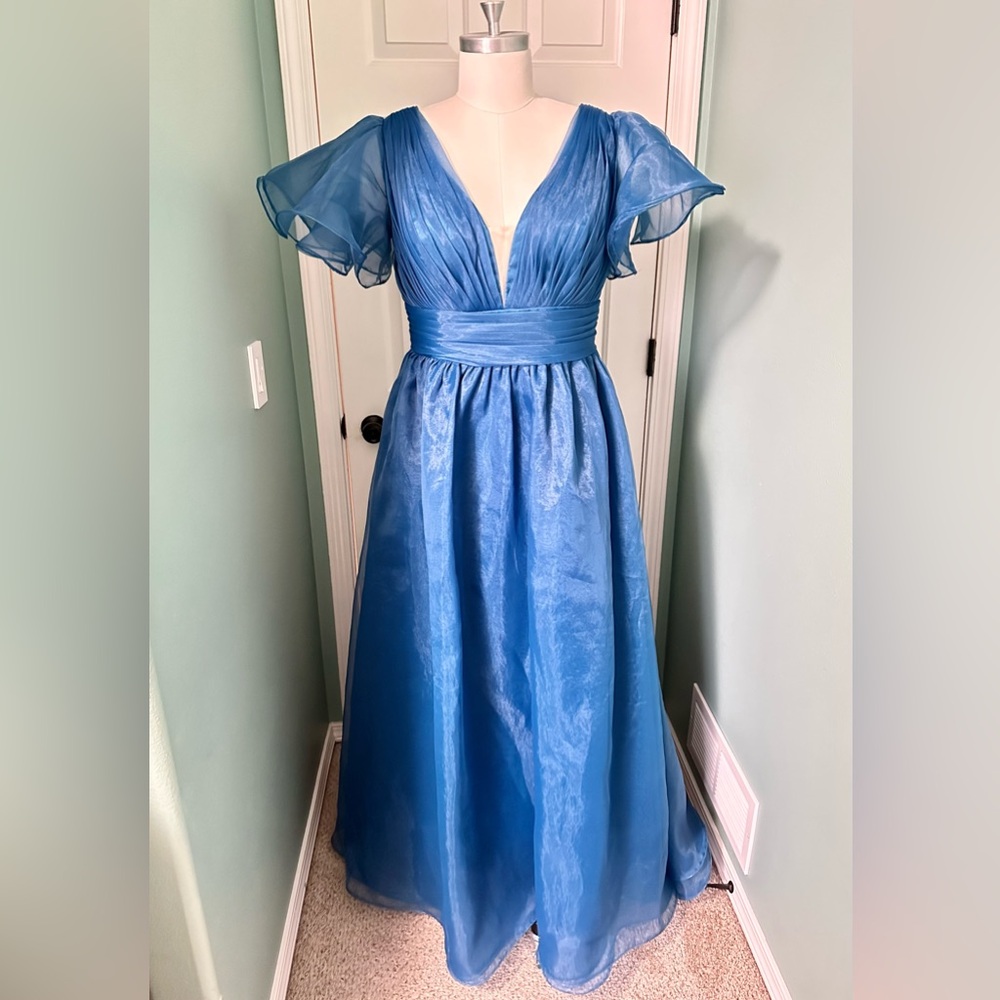 Women’s peacock blue plus size formal gown with lace up back.